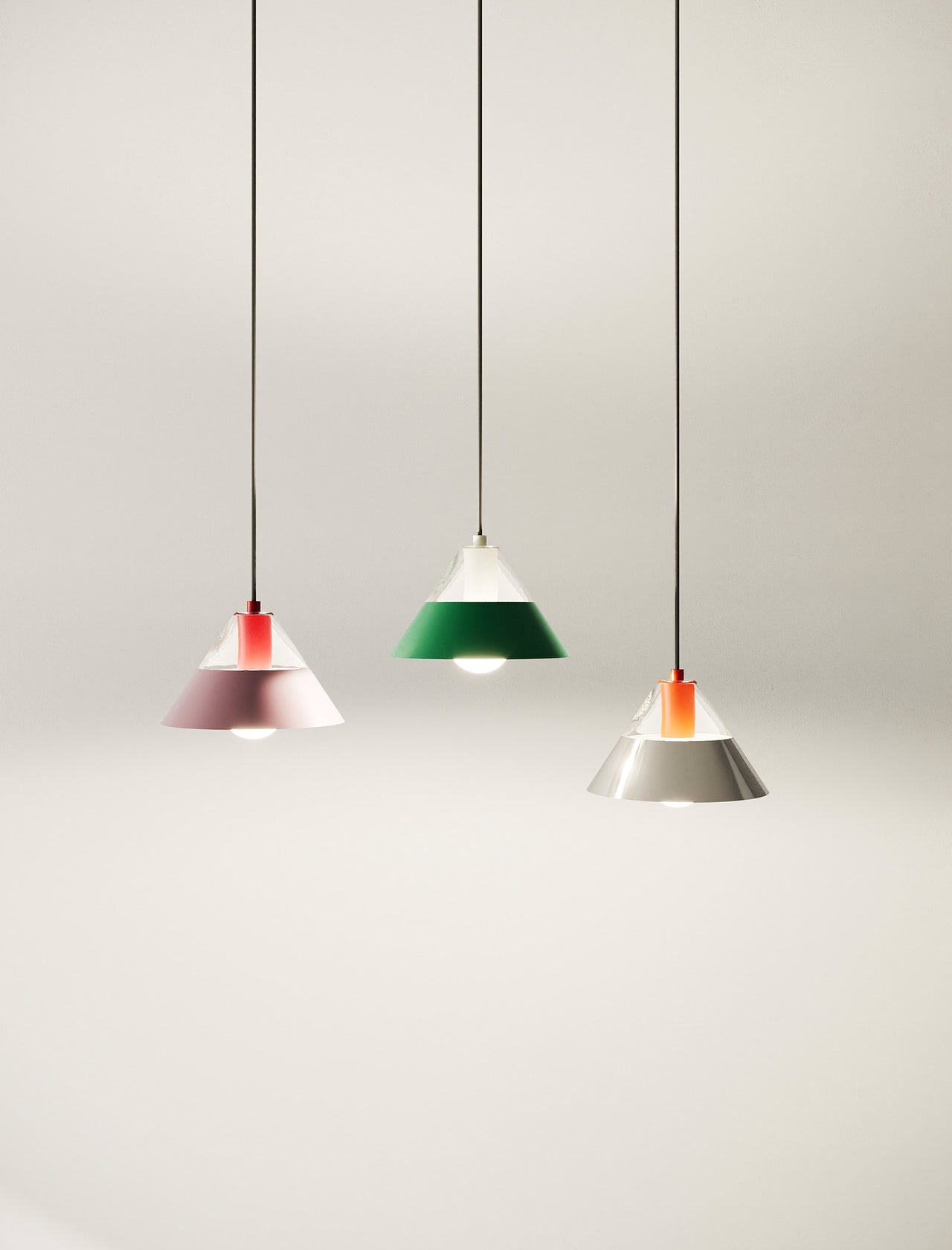 FIFTY FIFTY Lamp group of seven colorful pendant lamps with metal shades hanging against a white wall.