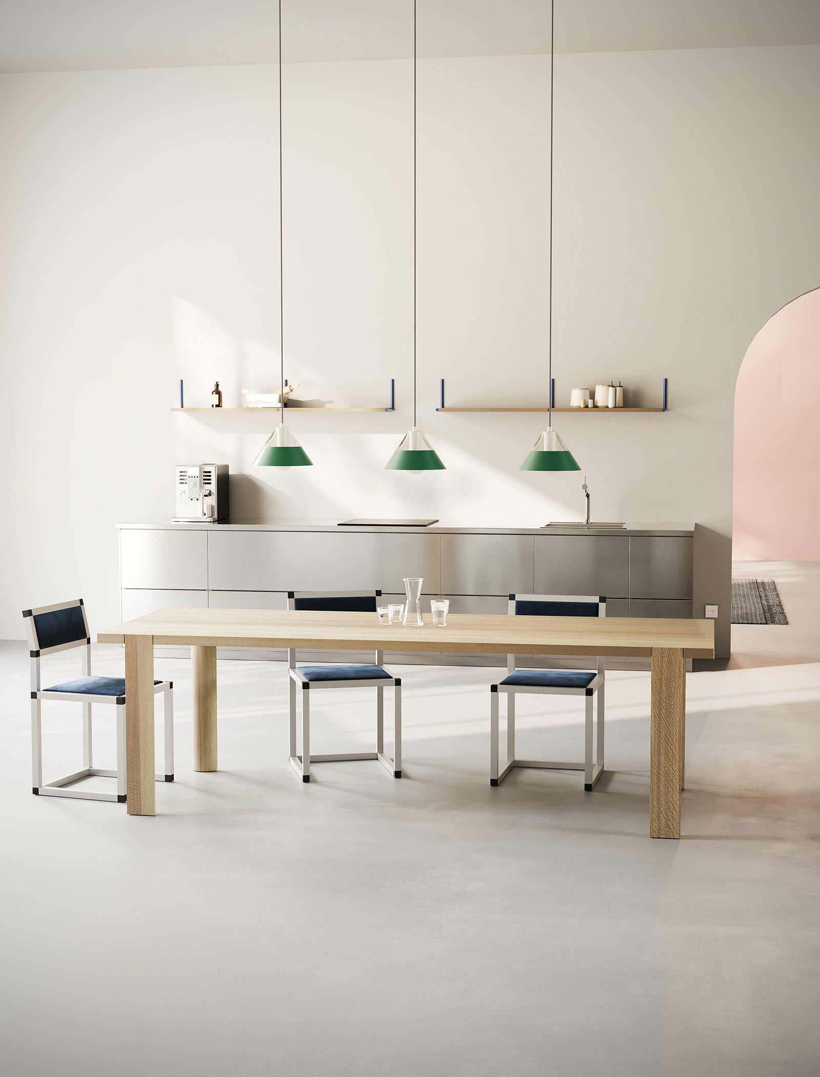 FIFTY FIFTY Lamp with green metal shades above a minimalist wooden dining table in a modern kitchen setting.