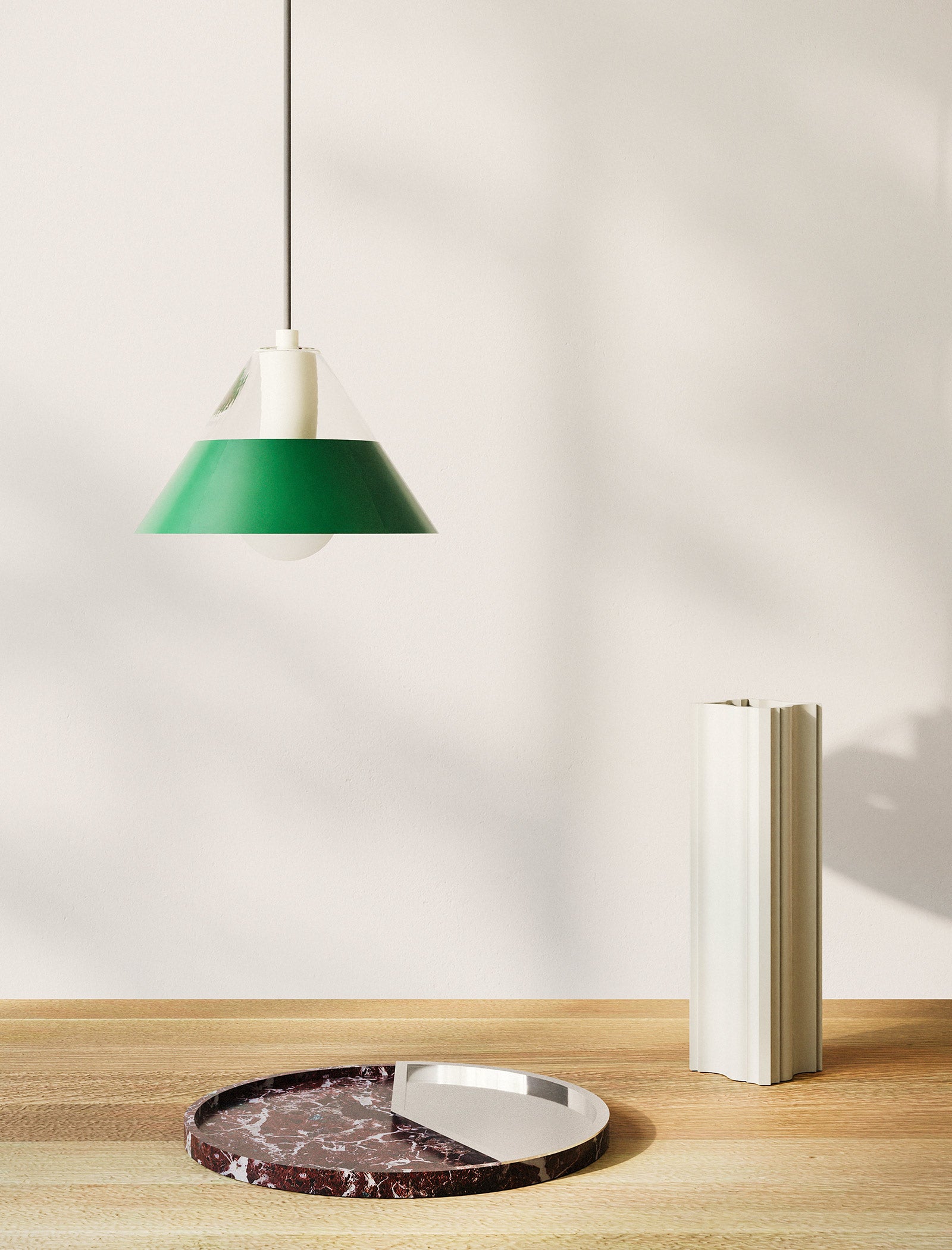 FIFTY FIFTY Lamp with green metal shade and glass upper shade casting warm, focused light over wooden table.
