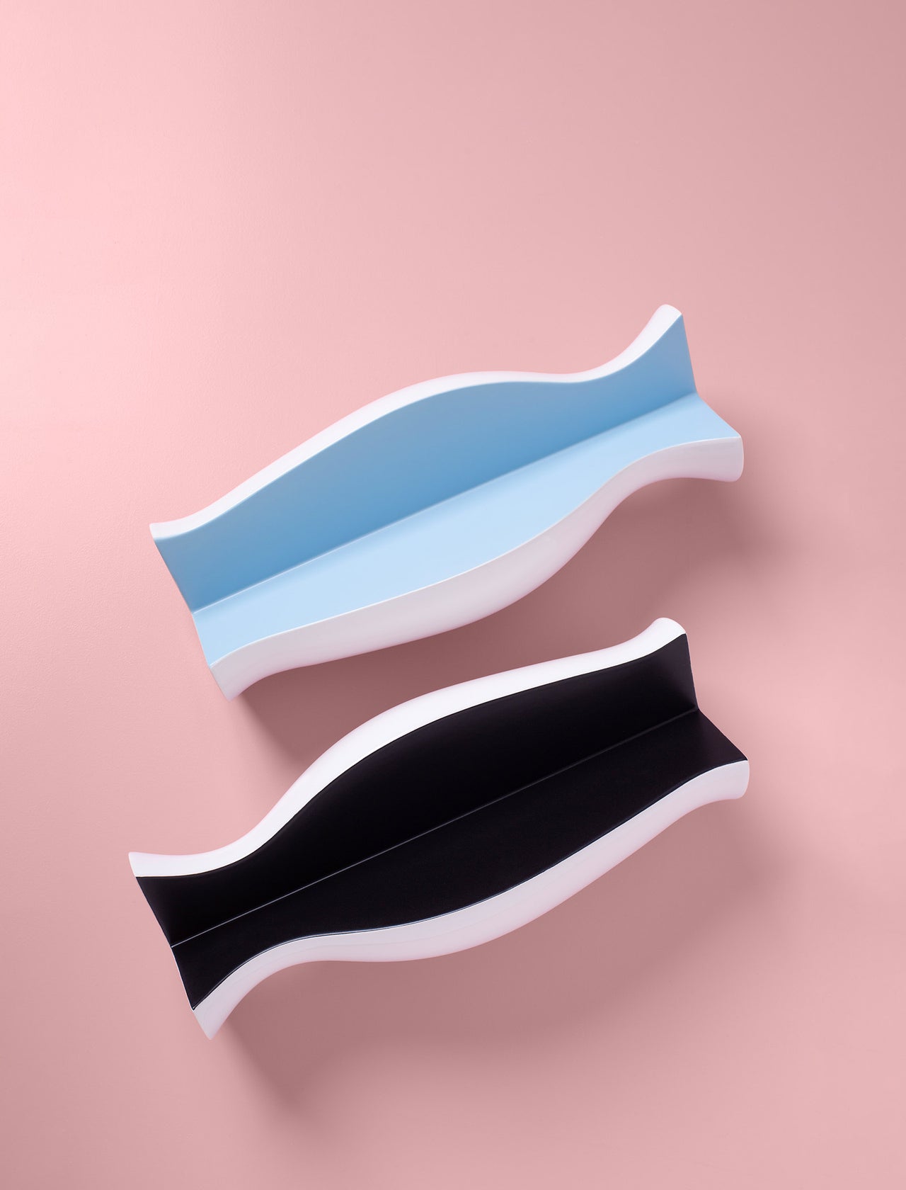 QUATER Vase - Three in black and blue colors, sculptural ceramic vase with amphora-inspired curved design on pink background.