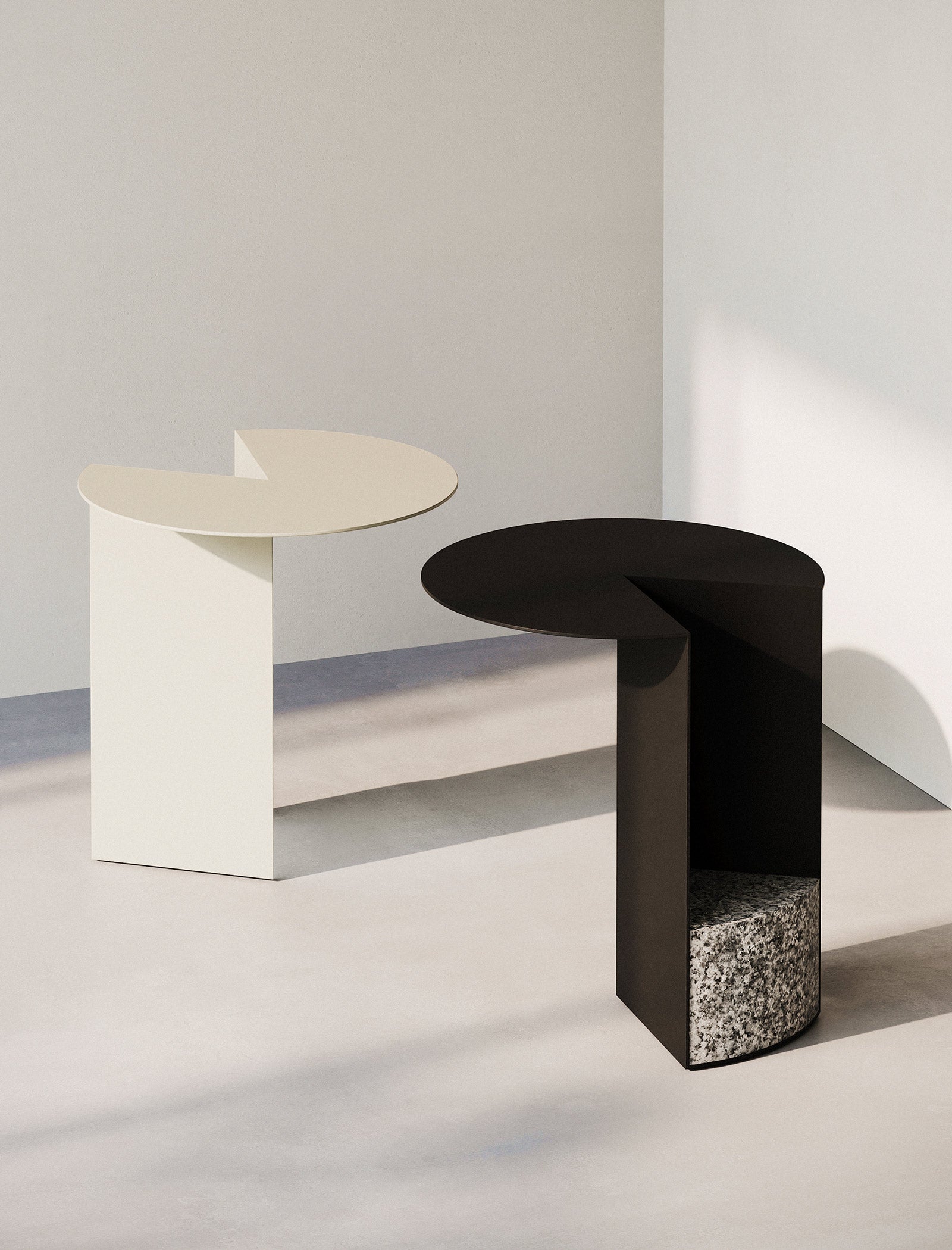 PAC Side Table - 700 with round aluminum top and solid granite base, available in black and white colors.