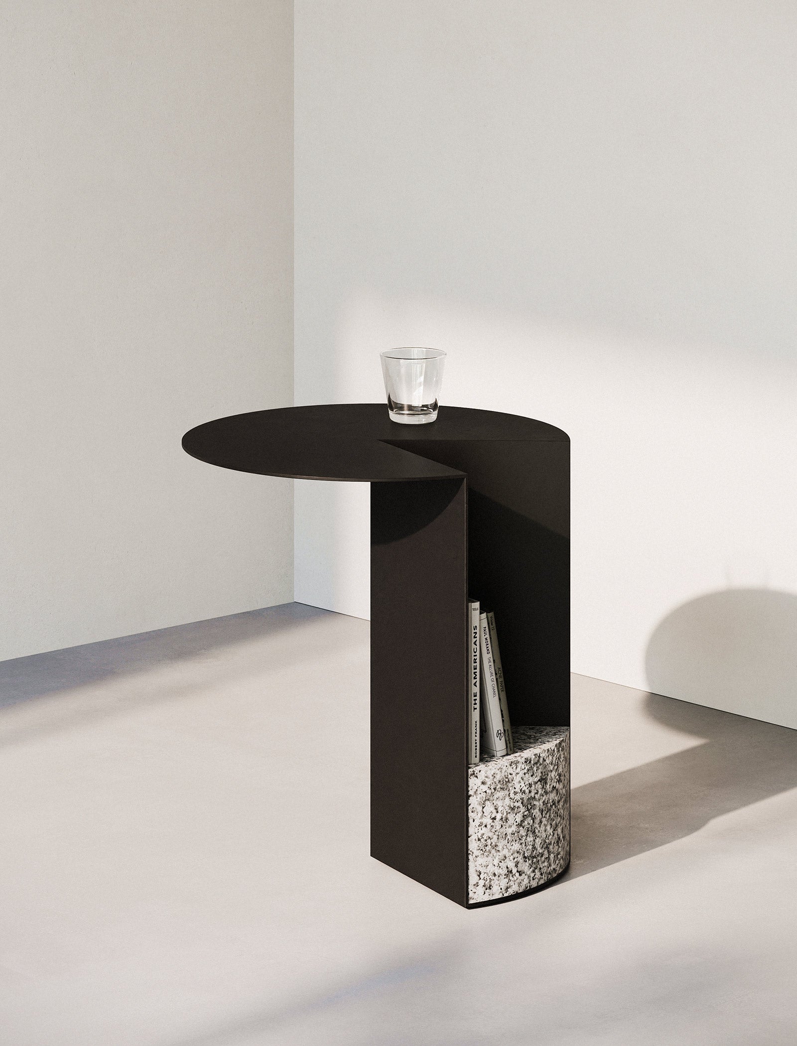 PAC Side Table - 700 with round black aluminum top and sturdy granite base, featuring a built-in magazine holder.