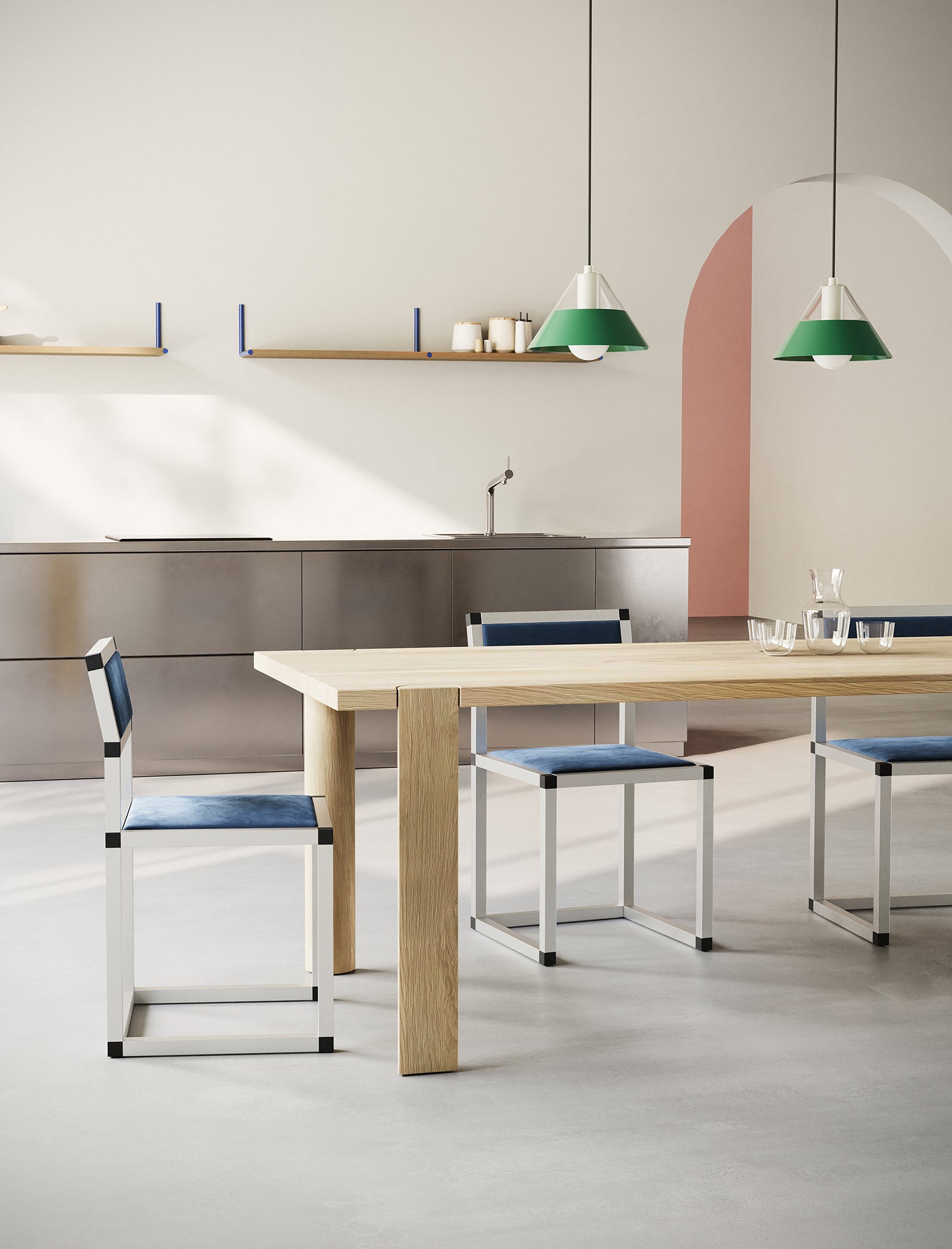 EVERYDAY Table made of solid wood with four rounded legs in a modern kitchen setting with blue chairs and pendant lamps