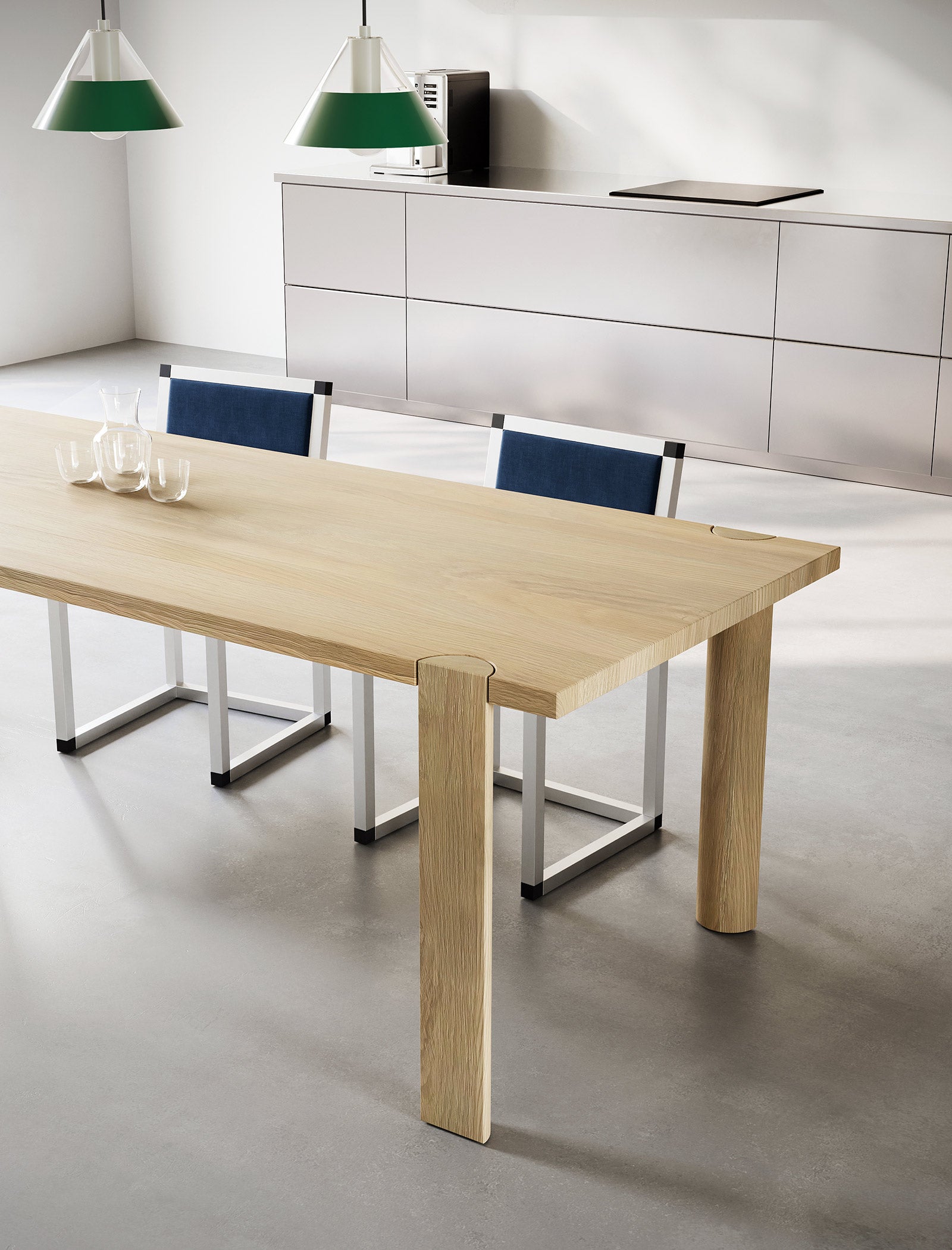 EVERYDAY Table made of solid wood with four half-round legs and visible end grain on the tabletop in a modern kitchen.